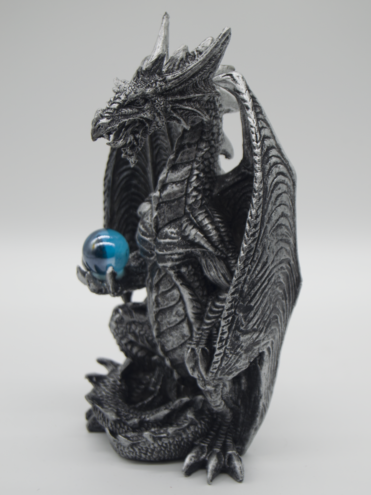Silver Dragon Holding A Blue Orb